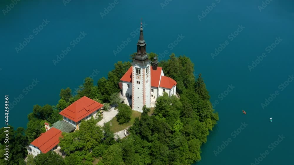 Top View Of The Church Of Mary The Queen On The Isle Of Lake Bled In Slovenia. aerial, orbit Top View Of The Church Of Mary The Queen On The Isle Of Lake Bled In Slovenia. aerial, orbit