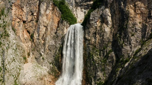 Mightiest Waterfall With Water Cascading Down On Limestone Cliff. Boka Waterfall In Triglav National Park In Slovenia. slow motion photo