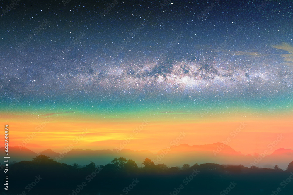 Milky way night landscape sunset rainbow light over silhouette mountain