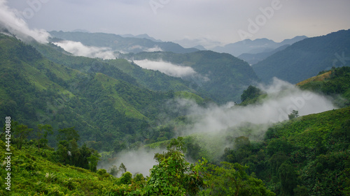 Scenic lush green tropical landscape panorama with low clouds in the mountains of Arunachal Pradesh, India