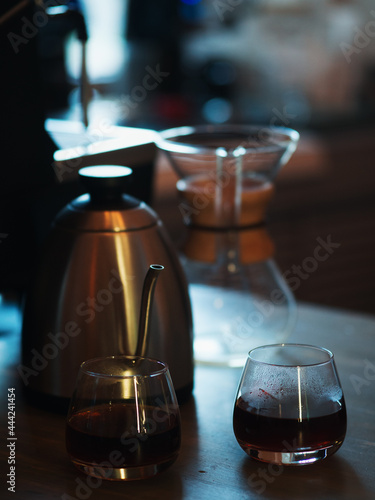 Two glasses of espresso coffee prepared by an alternative method in kemex photo