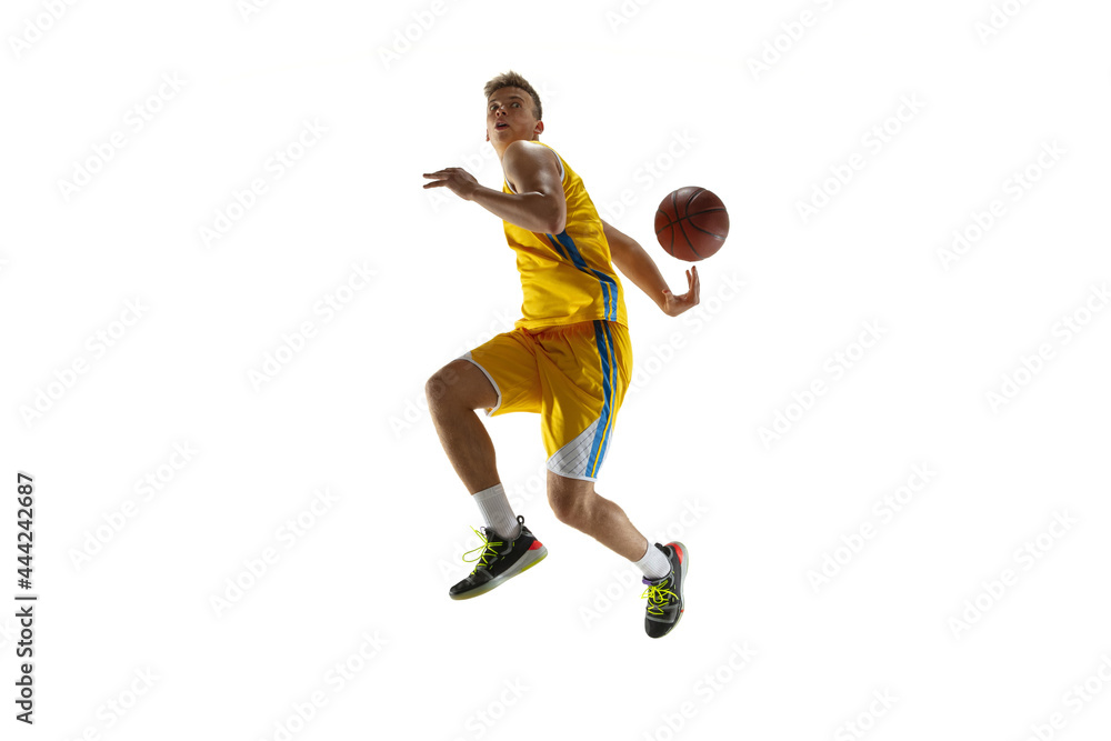 Side view. One young man, basketball player with a ball training isolated on white studio background. Advertising concept. Caucasian athlete in action.