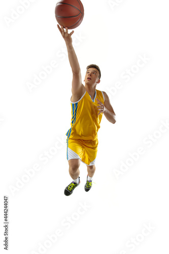 Full length portrait of a basketball player with a ball isolated on white studio background. Advertising concept. Fit Caucasian athlete jumping with ball. © master1305
