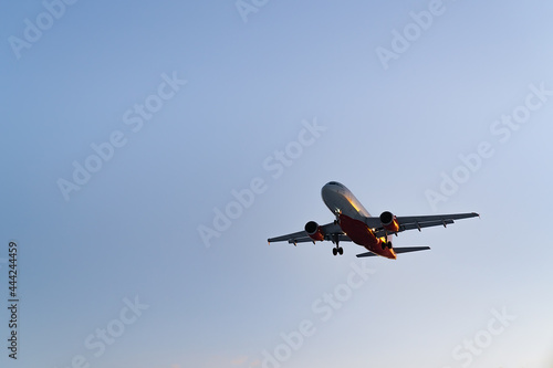 The plane comes in for landing at sunset