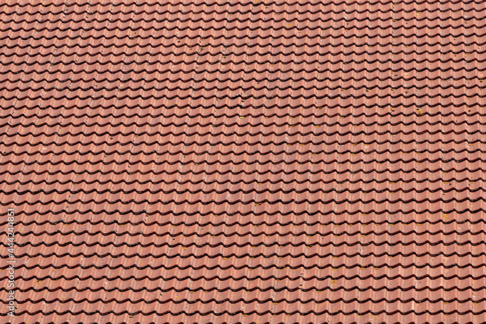 Red tiles background details, Old orange roof brick under the sun, Shingles texture, Abstract geometric pattern, Roof top material. Red tiles background details, Old orange roof brick under the sun, Shingles texture, Abstract geometric pattern, Roof top material.
