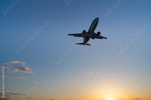 The plane comes in for landing at sunset