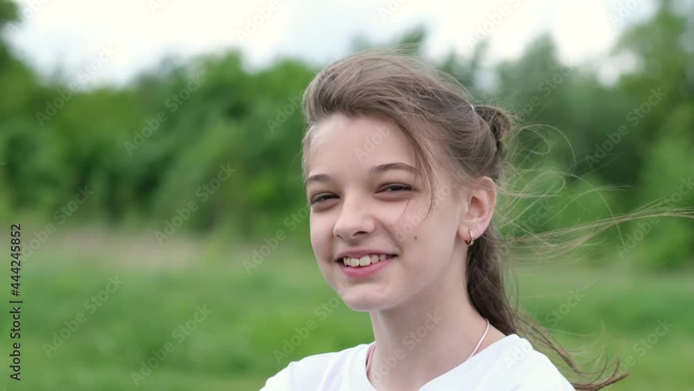 teen girl with natural make-up walks in nature on a sunny day. teenage posing outdoors straightened long hair. teen girl with natural make-up walks in nature on a sunny day. teenage posing outdoors straightened long hair.