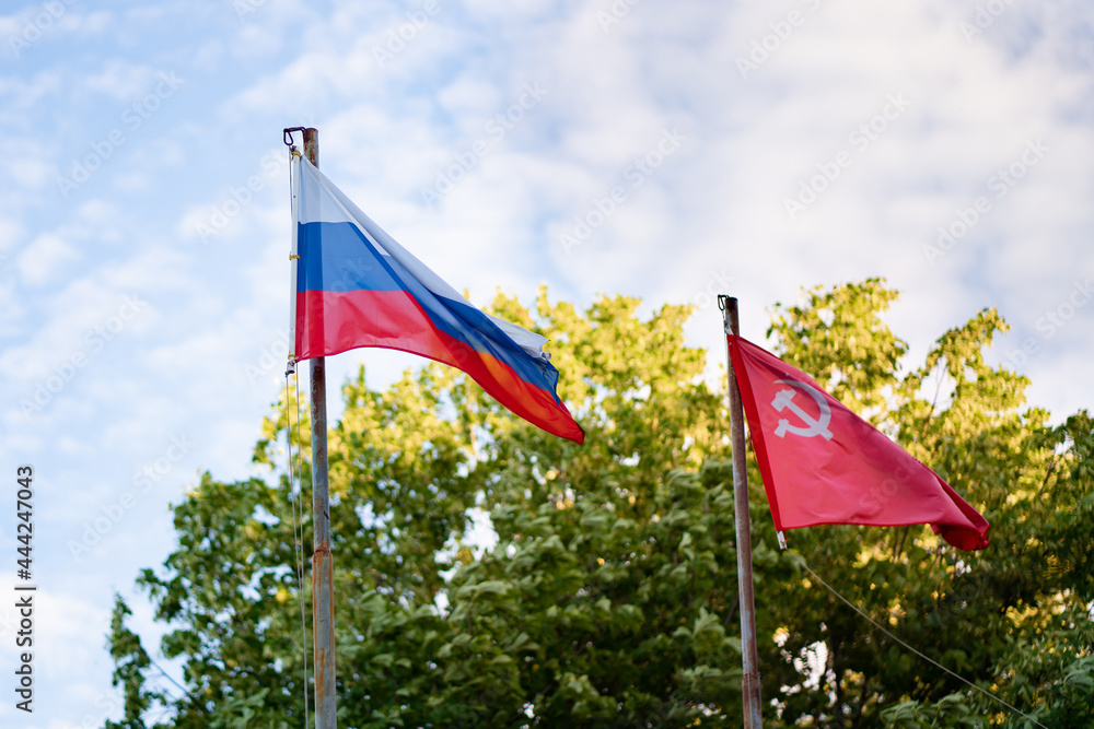 Russian flag and red banner of victory in great patriotic war in wind Russian flag and red banner of victory in great patriotic war in wind