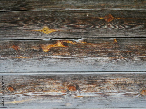 Texture of old wooden boards. Yellow resin appears on brown planks.