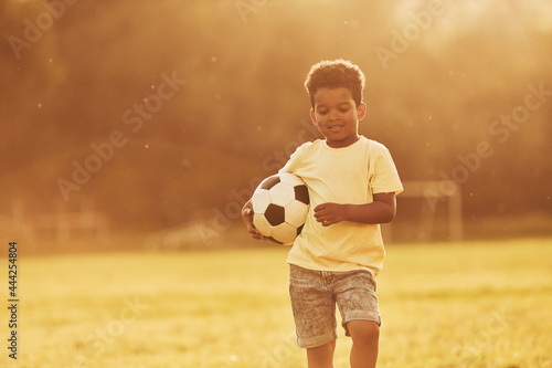 Young soccer player. African american kid have fun in the field at summer daytime © standret