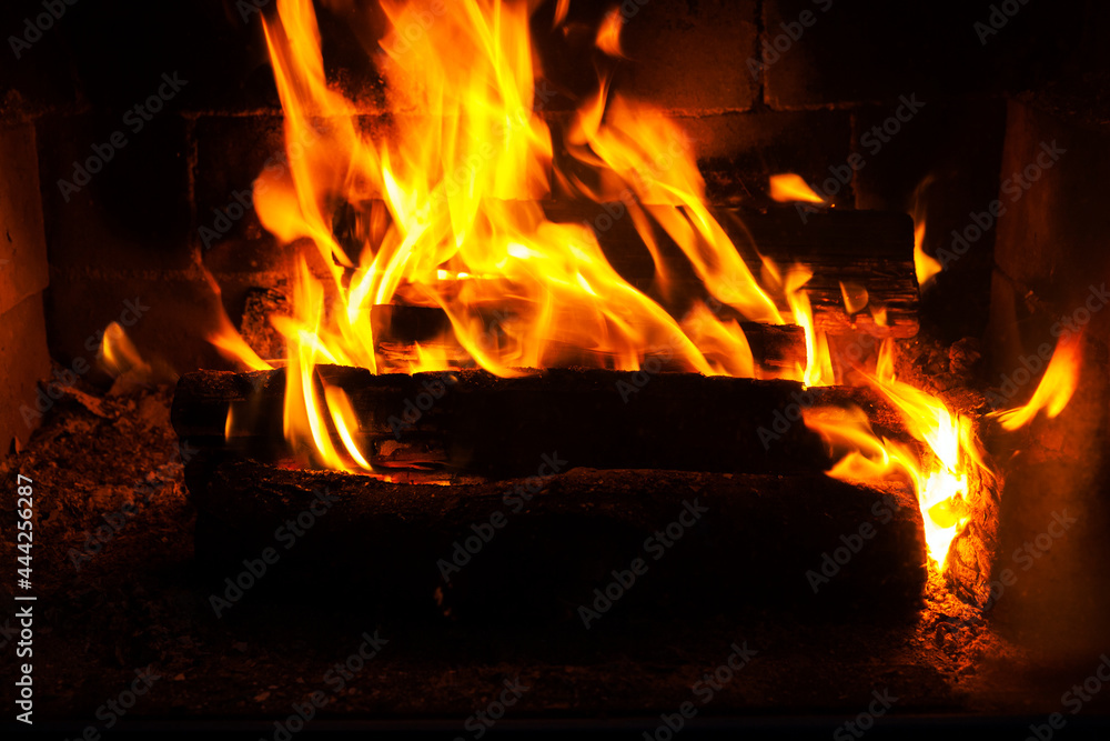 burning logs in the fire of a barbecue or stove or fireplace burning logs in the fire of a barbecue or stove or fireplace