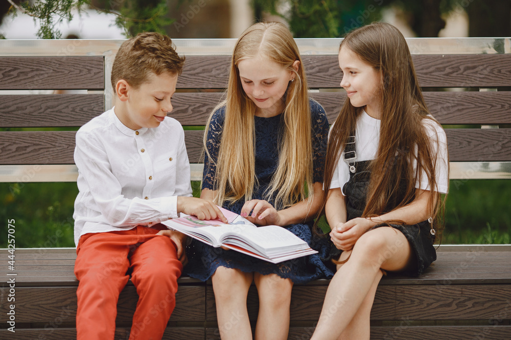 Happy children sitting together close and smile Happy children sitting together close and smile