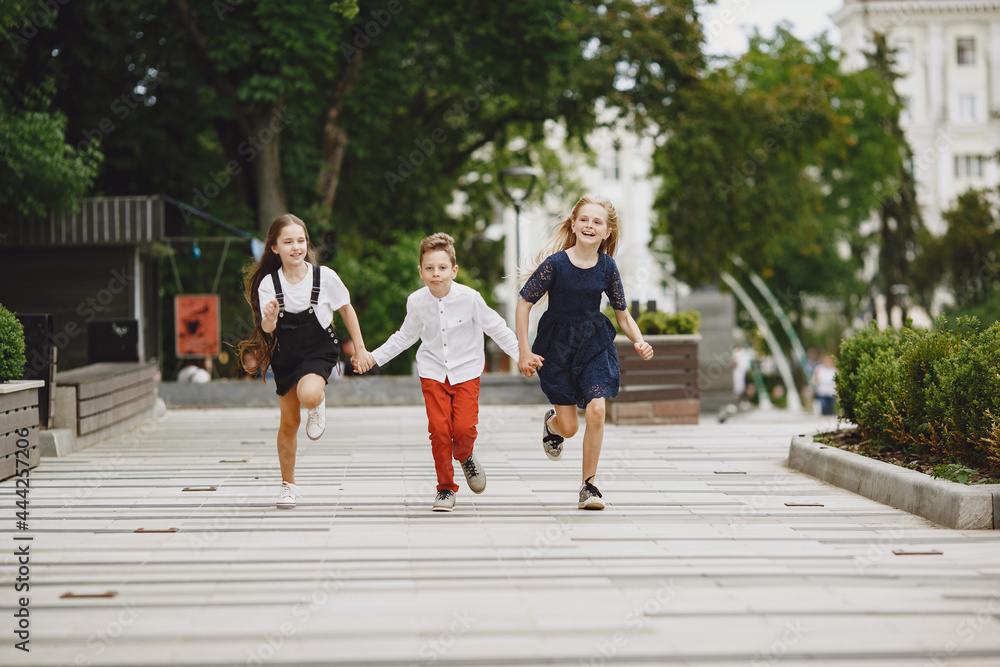 Fototapeta premium Happy children spend time together in a summer city