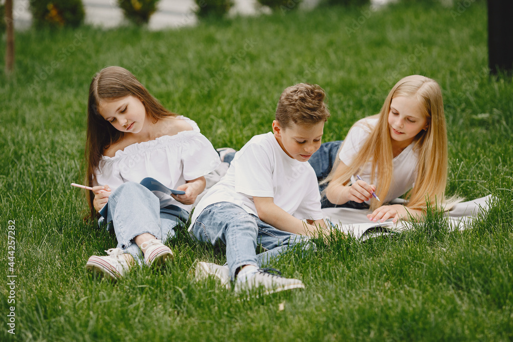 Happy children sitting together close and smile Happy children sitting together close and smile
