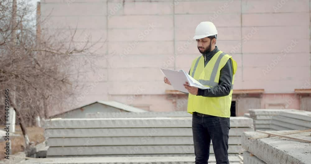 Single Working Man Outdoors Construction with Notepad Single Working Man Outdoors Construction with Notepad