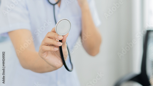 Female doctor holding a stethoscope, medical concept