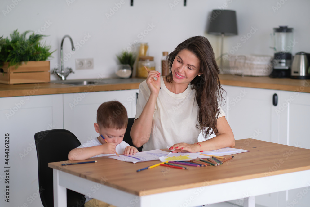 little boy learns to draw. Mom and son have fun drawing with pencils. Children's creativity. little boy learns to draw. Mom and son have fun drawing with pencils. Children's creativity.