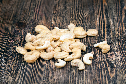 cashew nuts on an old wooden table, close up