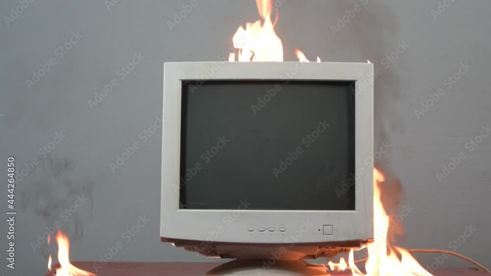 An old computer monitor is on fire. Fire hazardous situation in the ...