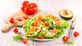 vegetable salad with avocado and salmon fillet