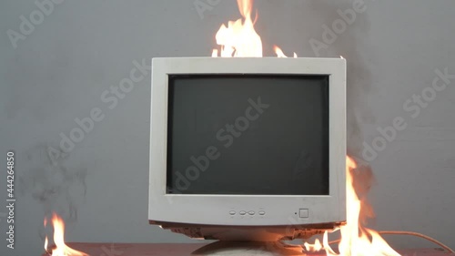 An old computer monitor is on fire. Fire hazardous situation in the apartment, causes of fire, short circuit.
