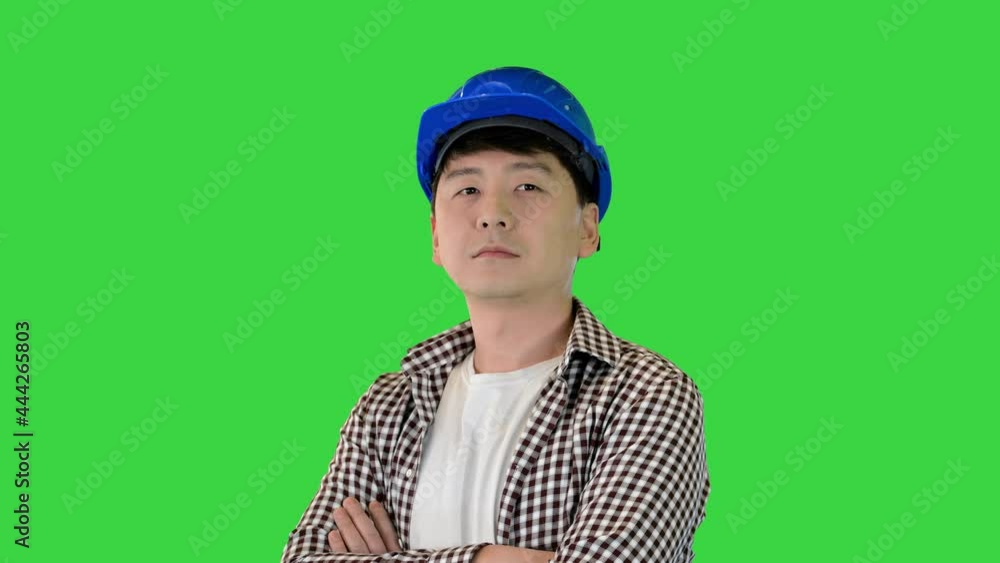 Construction worker in a hardhat changing poses and looking to camera on a Green Screen, Chroma Key. Construction worker in a hardhat changing poses and looking to camera on a Green Screen, Chroma Key.