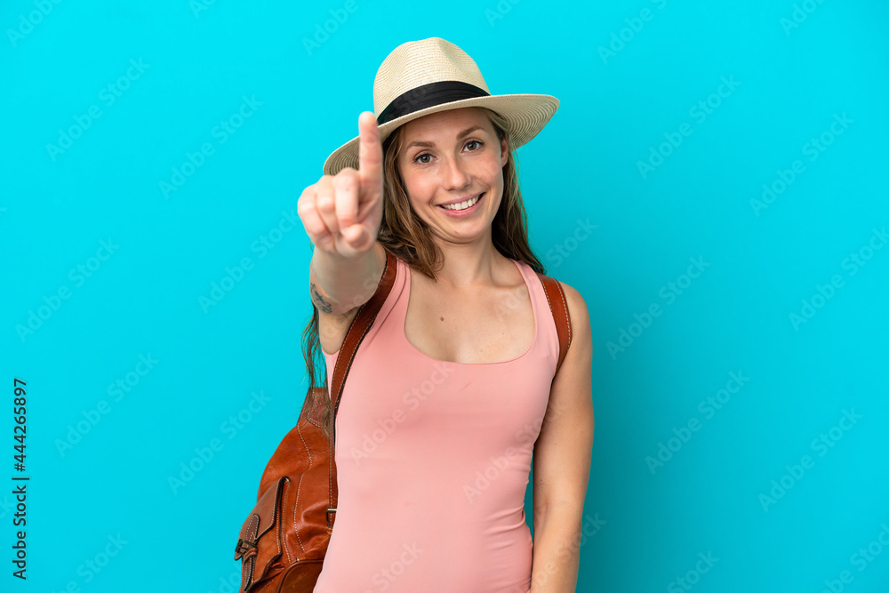 Young caucasian woman in summer holidays isolated on blue background showing and lifting a finger Young caucasian woman in summer holidays isolated on blue background showing and lifting a finger