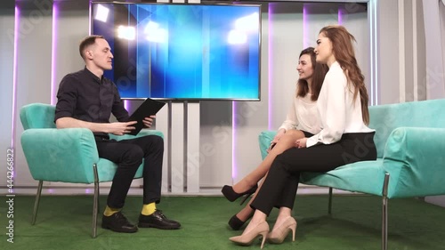 Tv host on talk show with two women guests