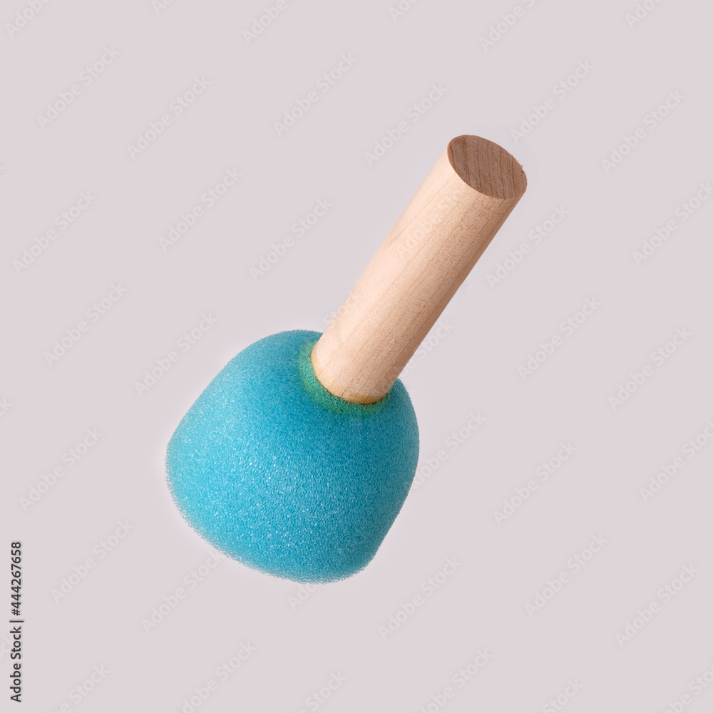 Blue sponge on a wooden handle isolated on white background Blue sponge on a wooden handle isolated on white background