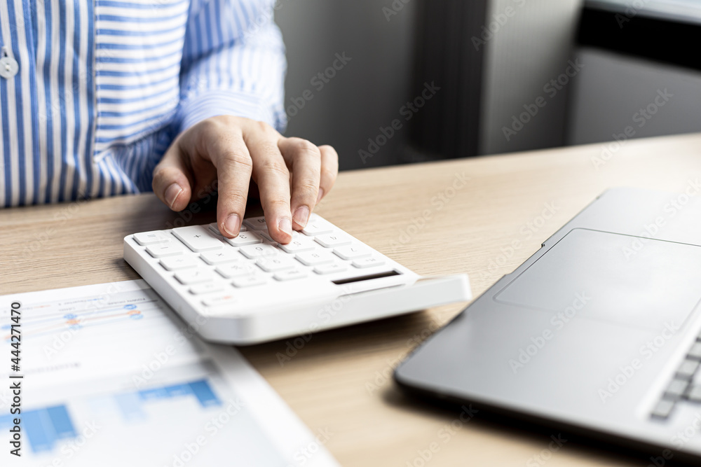 Female auditor pressing white calculator, she is a private company ...