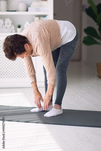 athletic mature woman exercising at home, active lifestyle, 84 years old lady workout