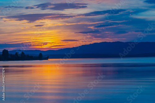 Summer sunset on the lake with mountain view