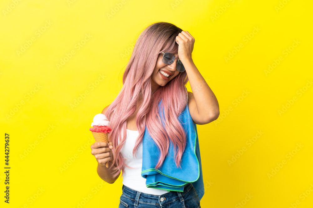 Young mixed race woman with pink hair holding ice cream isolated on yellow background has realized something and intending the solution Young mixed race woman with pink hair holding ice cream isolated on yellow background has realized something and intending the solution