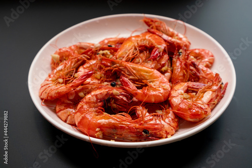 Delicious fried tiger prawns with minced garlic on the plate