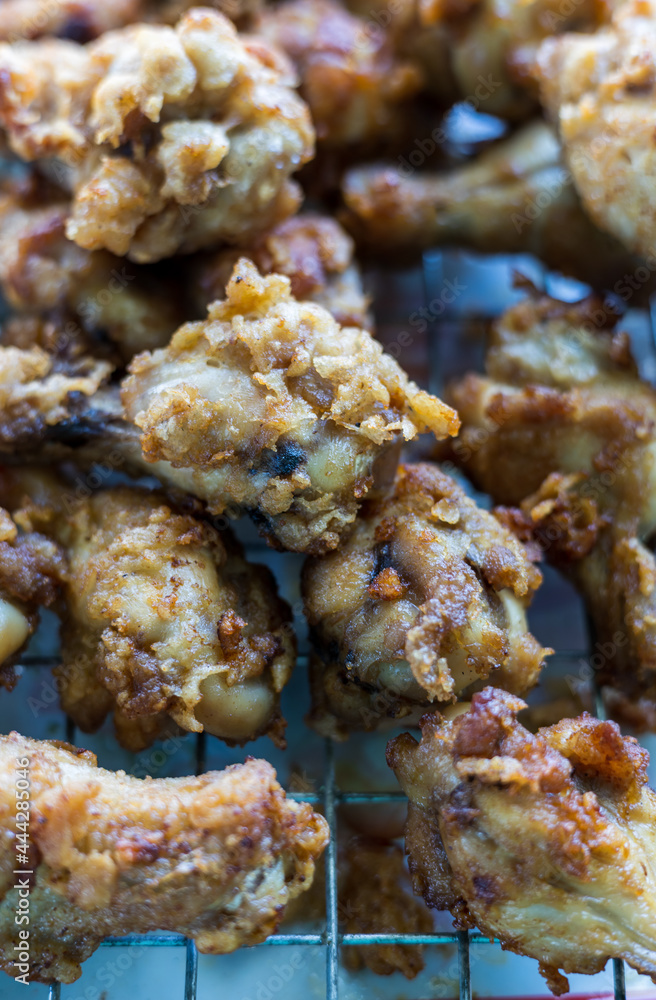 Plenty of pieces of chicken drumsticks are piled up on the grill. Plenty of pieces of chicken drumsticks are piled up on the grill.