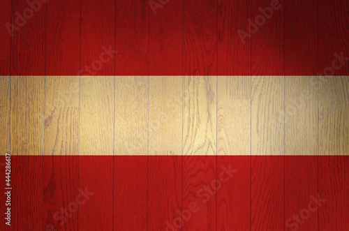 The flag of Austria on a grunge wooden background.
