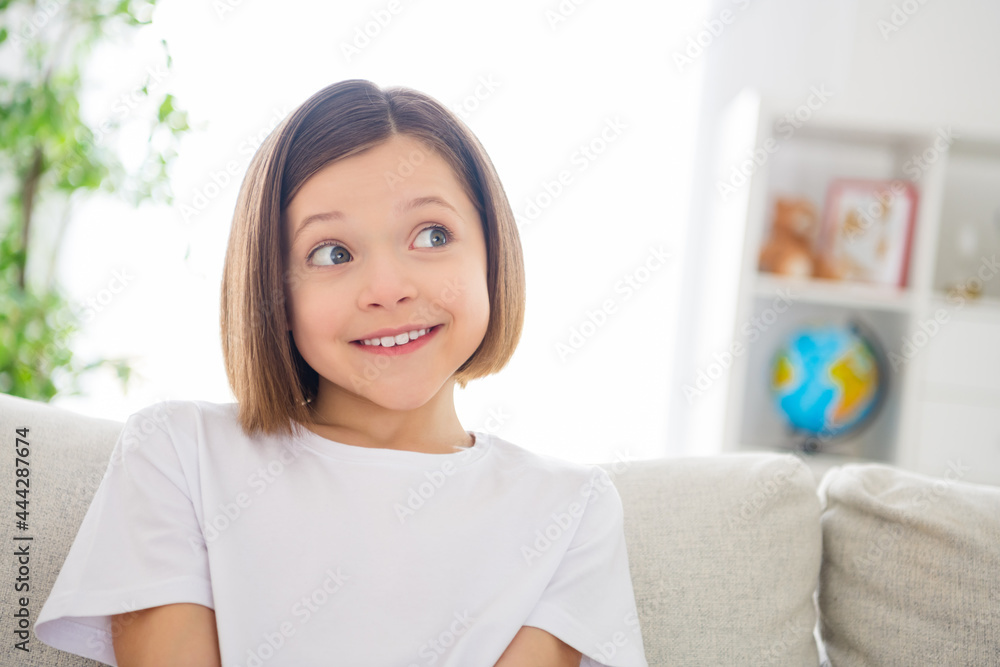 Photo of young attractive cheerful little girl happy positive smile dream dreamy think sit couch home Photo of young attractive cheerful little girl happy positive smile dream dreamy think sit couch home