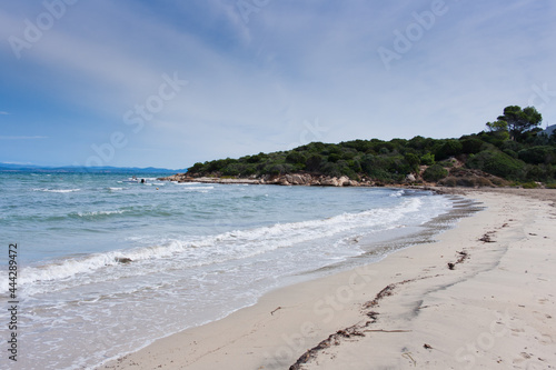 view of the beach and sea with little waves, resort on Sardinia island