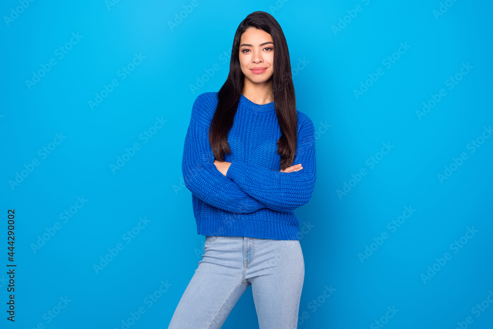 Photo portrait young girl smiling with crossed hands wearing casual outfit isolated bright blue color background Photo portrait young girl smiling with crossed hands wearing casual outfit isolated bright blue color background