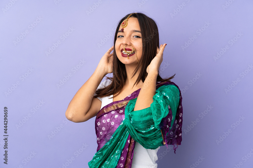 Young Indian woman isolated on purple background laughing Young Indian woman isolated on purple background laughing