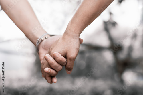 Conceptual image of female and male hands together, Couples holding hands.Summer in love.