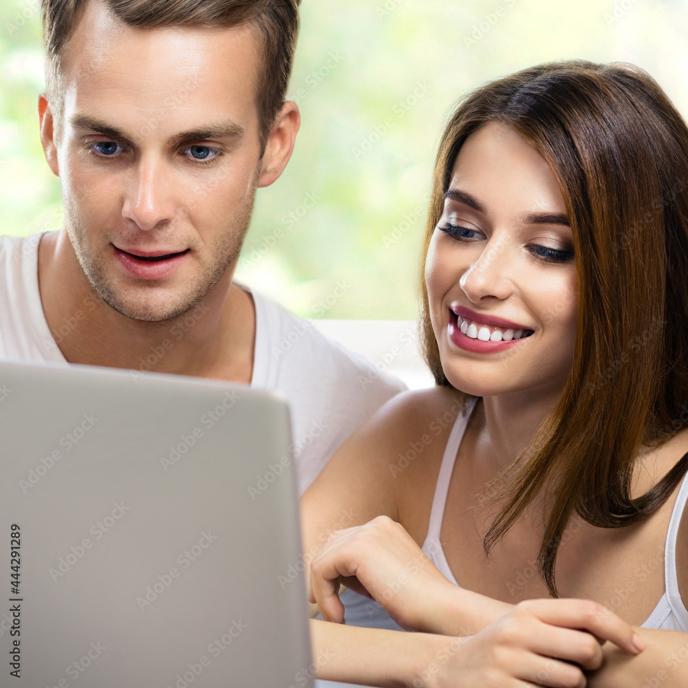 Image of smiling couple using laptop at home. Internet, shopping, online store, love, relationship concept - young man and woman with domestic computer. Square. Image of smiling couple using laptop at home. Internet, shopping, online store, love, relationship concept - young man and woman with domestic computer. Square.