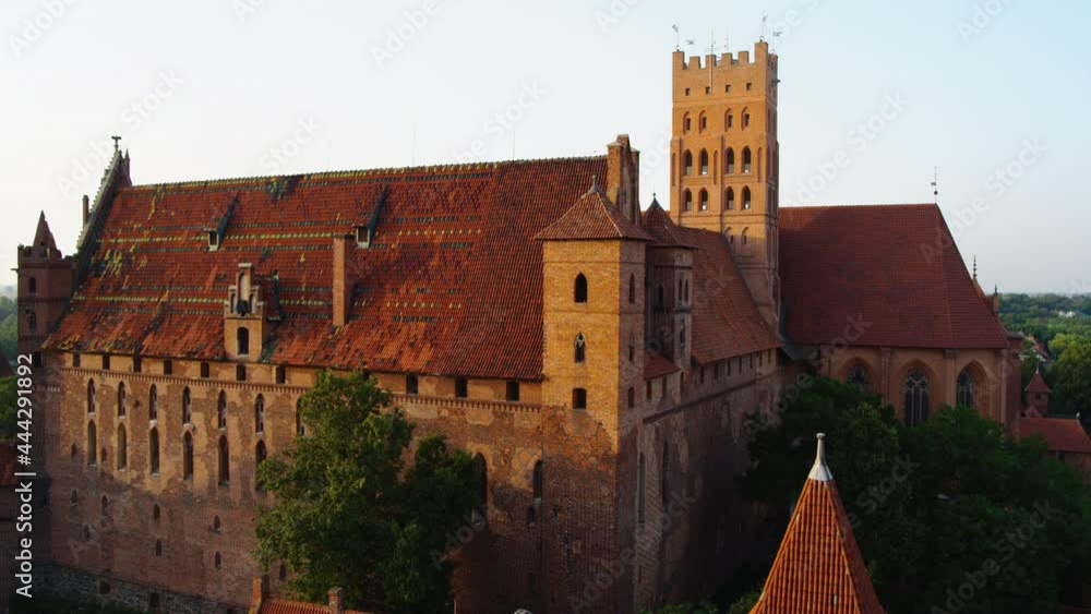 Aerial view of the Teutonic castle in Malbork. Located by the River Nogat, summer day view. Close up on walls and windows details Aerial view of the Teutonic castle in Malbork. Located by the River Nogat, summer day view. Close up on walls and windows details
