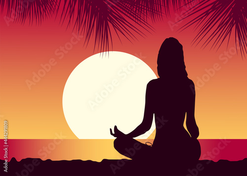 girl meditates on the beach at sunset