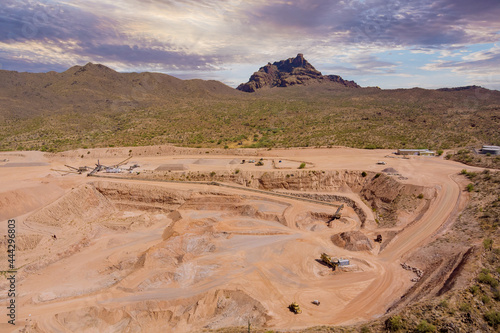 Heavy industry as a mining from above aerial view of excavator in open cast mine