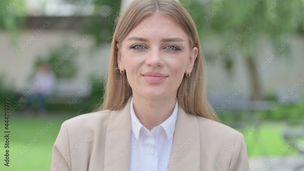 Outdoor Portrait of Young Businesswoman Shaking Head as Yes Sign Outdoor Portrait of Young Businesswoman Shaking Head as Yes Sign