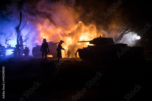 War Concept. Military silhouettes fighting scene on war fog sky background, World War Soldiers Silhouette Below Cloudy Skyline At night. Battle in ruined city. Selective focus © zef art