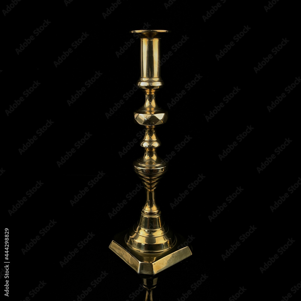 golden antique candlestick on black isolated background. antique candlestick