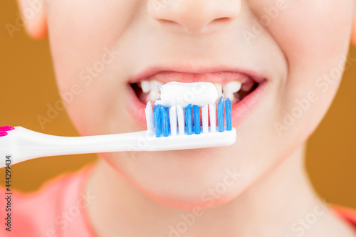 Health care, dental hygiene. Joyful child shows toothbrushes. Little boy cleaning teeth. Dental hygiene. Happy little kid brushing her teeth. Kid boy brushing teeth. Boy toothbrush white toothpaste