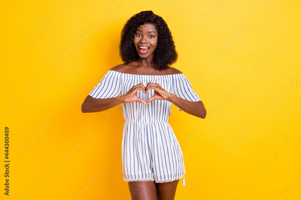 Portrait of attractive cheerful slim glad girl showing heart shape affection 14 February isolated over bright yellow color background Portrait of attractive cheerful slim glad girl showing heart shape affection 14 February isolated over bright yellow color background